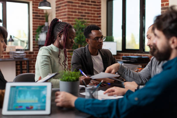 istock Diverse businesspeople working at marketing project 1457583349