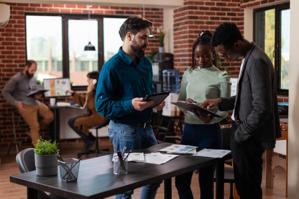istock Diverse businesspeople analyzing marketing statistics on tablet 1457583795