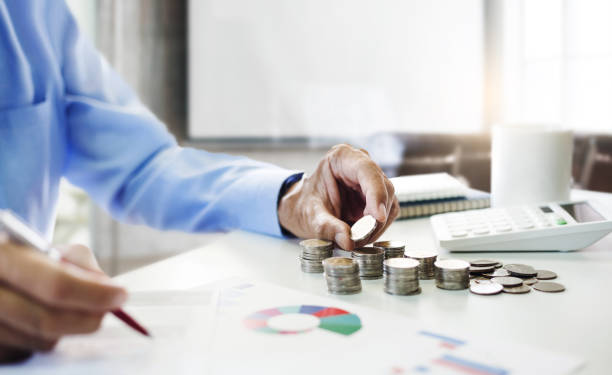 business and finance, people working Asian businessman or investor putting coin stack for budget and analysis stock financial indices, investment and financial accounting management, growing business concept cash value life insurance policies stock pictures, royalty-free photos & images