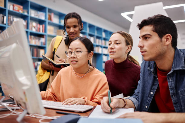 istock Diverse group of college students in library 1457587175