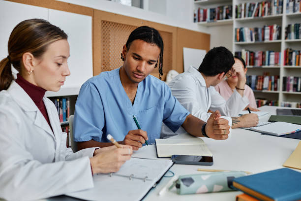 istock Diverse group of young medics and nurses working during meeting or seminar 1457587294