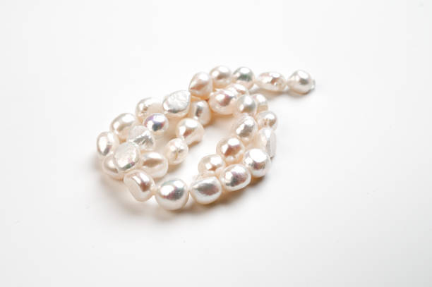 istock Natural freshwater round pearl beads on white background. Top view 1457590644