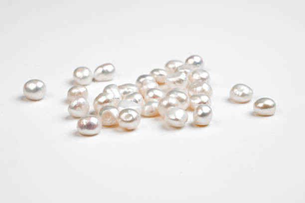 istock Natural freshwater round pearl beads on white background. 1457590700