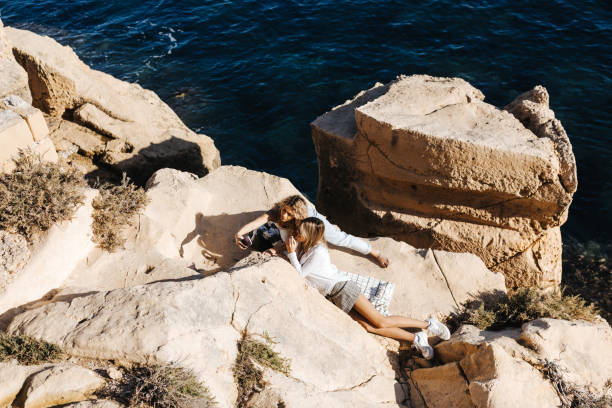 istock Female friends having fun at the seaside 1457591633