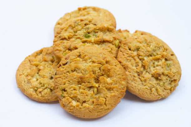 istock Pistachio and almond cookies on white background. 1457591711