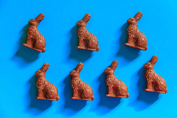 istock Easter chocolate bunnies on blue background. Top view 1457591780