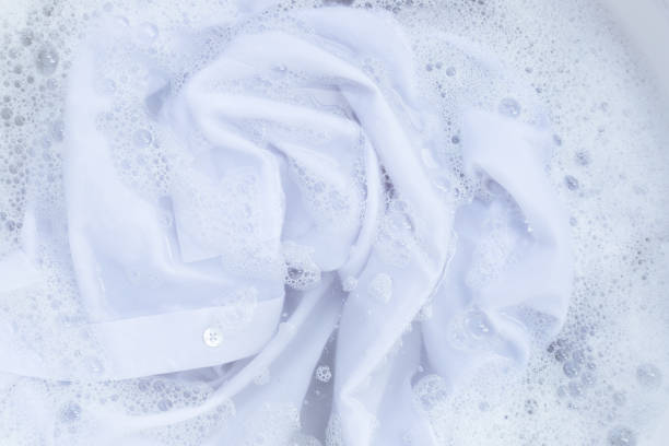 istock Top view of formal shirts soak in powder detergent water dissolution. Laundry concept 1457592515