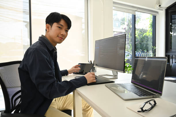 istock IT specialist man checking debugging system on large curved monitor, working in startup company office. 1457595720