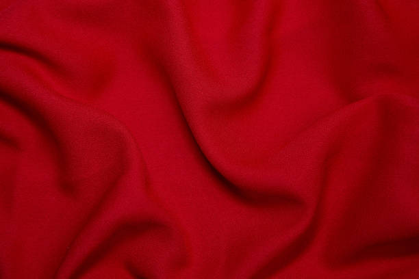 istock Red fabric background. Red cloth waves background texture. Red fabric cloth textile material. 1457597624