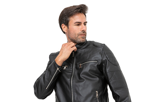 Handsome middle-aged hispanic stubby bearded man on white studio. Short-haired handsome man in leather jacket and t-shirt, on white background.