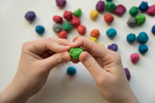 istock Colorful pieces of plasticine prepared for modeling in hands 1457602537