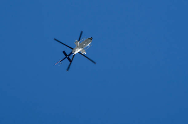 istock Helicopter against the blue sky 1457605978