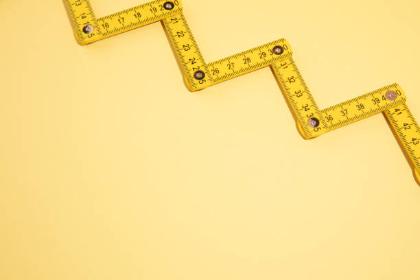 istock tape measure on the yellow background with copy space 1457608470