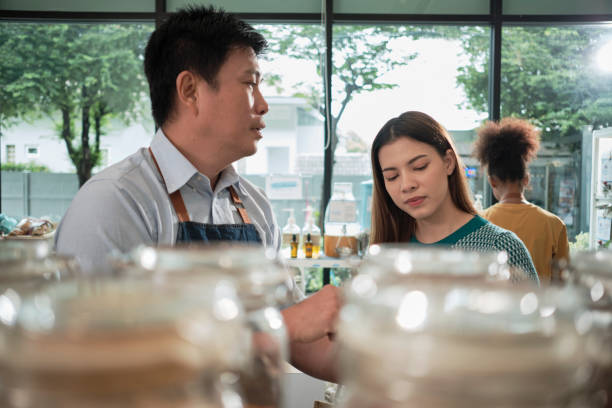 istock A shopkeeper and customer in refill store, zero-waste, and plastic-free grocery. 1457610571