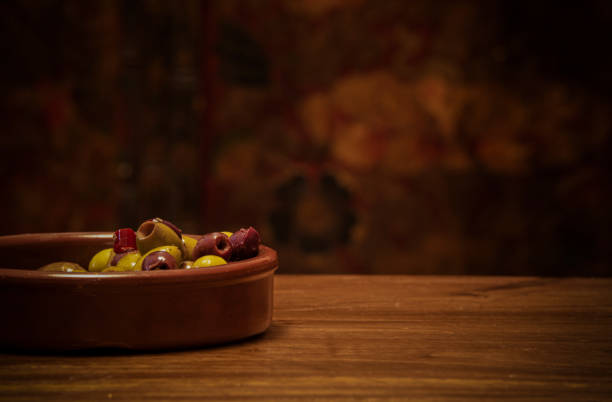 Bowl of olives on wooden table