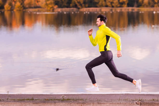 istock Handsome Fitness Runner Man During Road Training for High Intensity Interval Training and Sprint Workout Outdoors At Fall Near Scenic River Bank As Male Athlete Model 1457611469