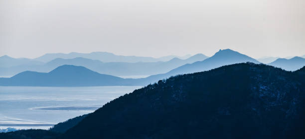 Panoramic coastal mountain landscape on a foggy evening. Busan, South Korea