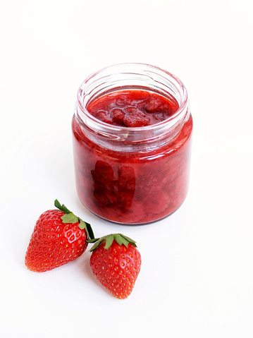 strawberry jam and fresh strawberries.