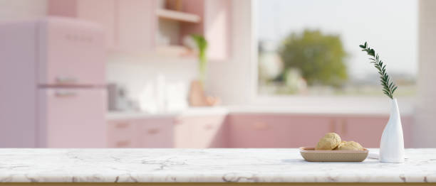 istock White marble kitchen tabletop with empty space over blurred beautiful pastel pink kitchen room 1457617484