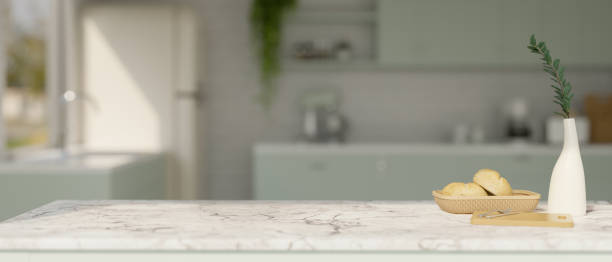 istock Luxury white marble tabletop with copy space over blurred beautiful kitchen in the background. 1457617529