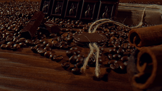 Composition of cinnamon sticks. dark chocolate bars and coffee beans