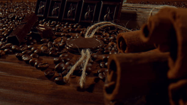 istock Composition of cinnamon sticks, dark chocolate bars and coffee beans 1457617693