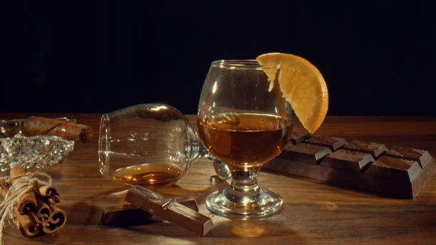 glass of cognac or brandy maybe whiskey and a cigar on an ashtray - cigar whisky bar cognac imagens e fotografias de stock