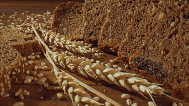 istock Grain rye bread slices around ears of wheat 1457619755