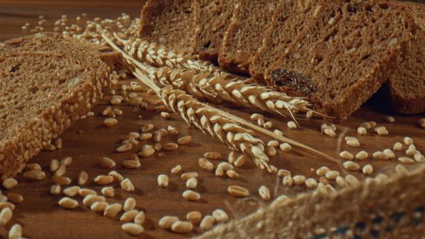 istock Grain rye bread slices around ears of wheat 1457619759