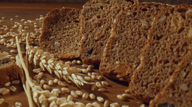 istock Grain rye bread slices around ears of wheat 1457619762