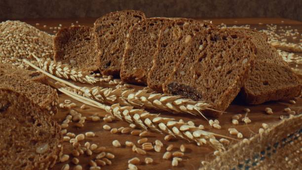 istock Grain rye bread slices around ears of wheat 1457619771