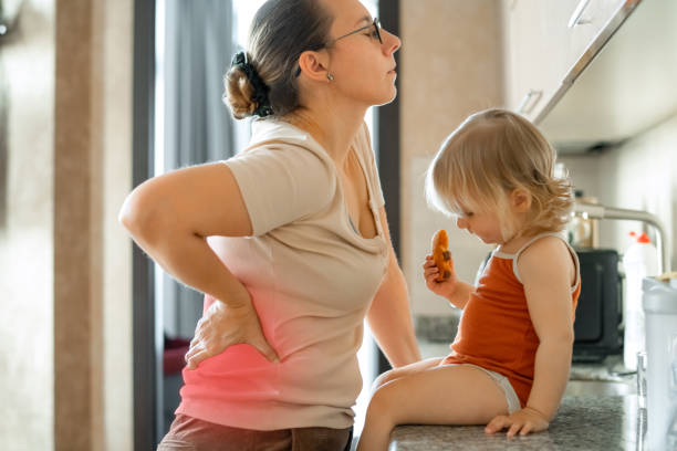 Young mother suffering from backache stock photo