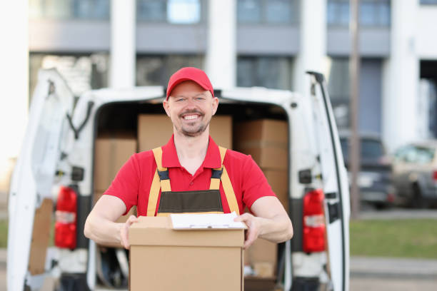 istock Person carrying package from delivery vehicle closeup 1457638393