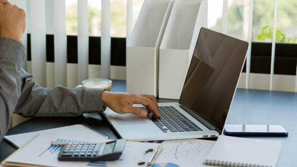 istock Businessman hands on keyboard of laptop computer showing data analysis graph Businessman working and analyzing financial figures on graph document 1457639517