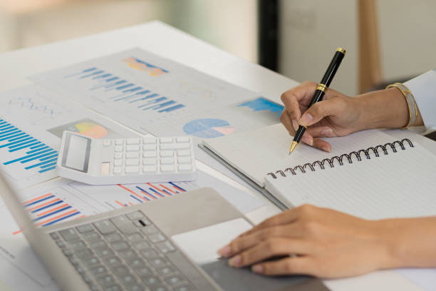 istock Businessman hands on keyboard of laptop computer showing data analysis graph Businessman working and analyzing financial figures on graph document 1457639535