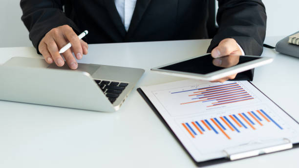 istock Businessman hands on keyboard of laptop computer showing data analysis graph Businessman working and analyzing financial figures on graph document 1457639539
