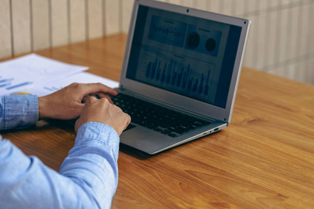 istock Businessman hands on keyboard of laptop computer showing data analysis graph Businessman working and analyzing financial figures on graph document 1457639546