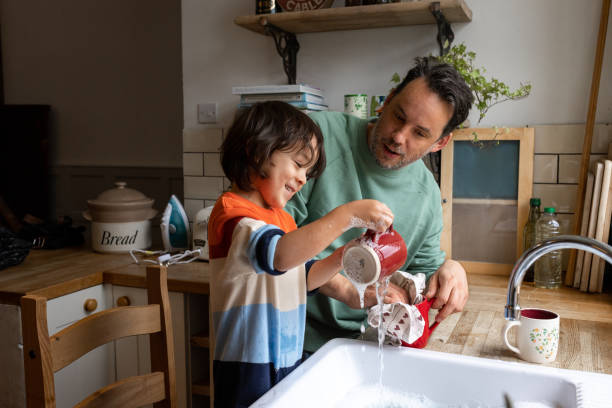 momentos junto con son - lavar los platos fotografías e imágenes de stock