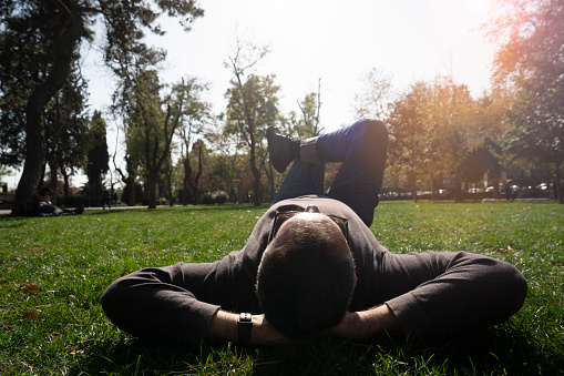 boy and girl relax on green grass, kids on summer vacation in nature