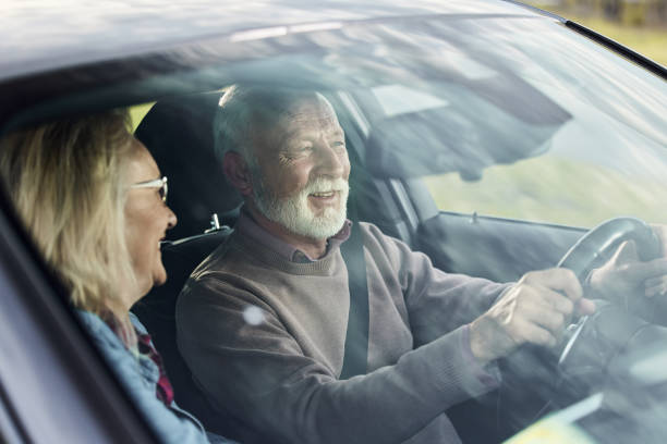istock Happy senior couple going on a trip by car. 1457640622