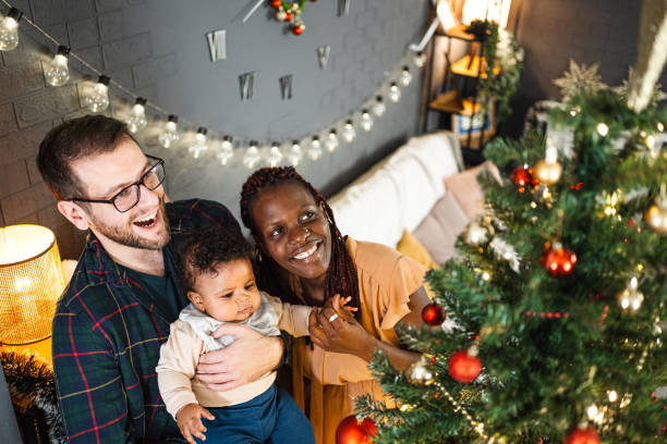 istock Young family decorating a Christmas tree 1457641479
