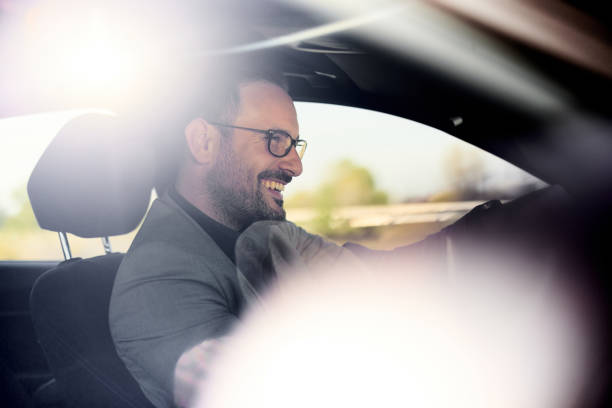 istock Happy businessman going on a trip by car. 1457641497