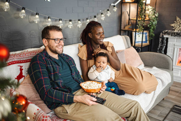 istock Happy young family watching tv 1457641518