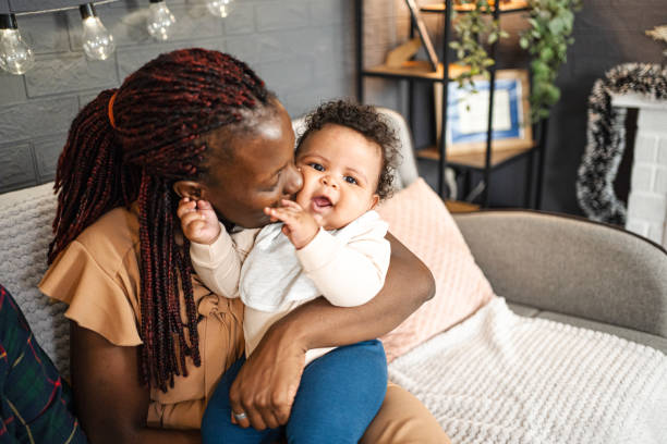 istock Mother kissing her baby 1457641543