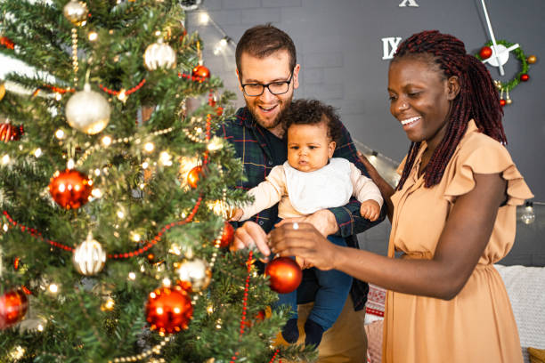 istock Young family decorating a Christmas tree 1457641669