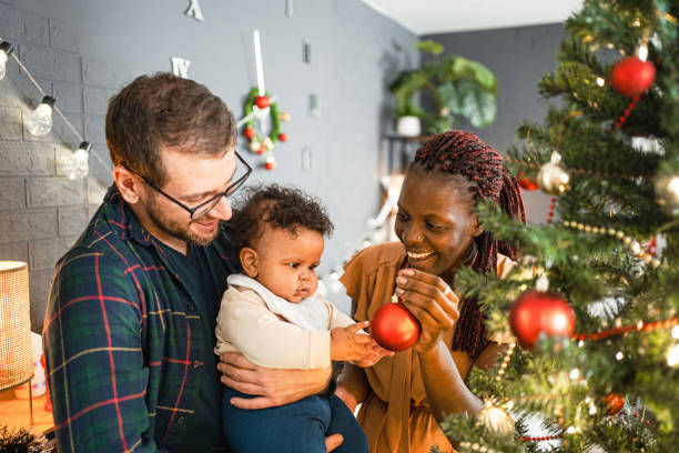 istock Young family decorating a Christmas tree 1457641689