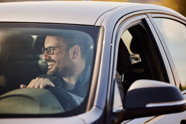 istock Young happy businessman going on a trip by car. 1457642285