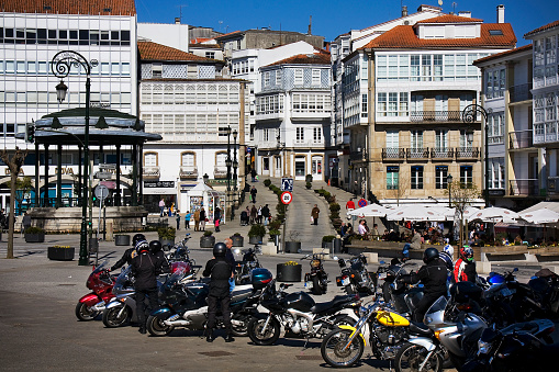 Betanzos, Spain_March 6, 2011: Stationary motorcycles in main old town square, Betanzos, A Coruña province, Galicia, Spain. Bandstand, galerías, sidewalk cafes.