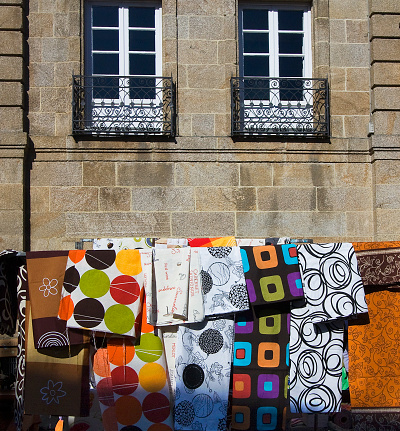 Market  stall seen from the street selling multi coloed quilts, Betanzos historic district, A Coruna province, Galicia, Spain.