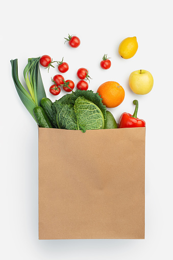 paper bag with groceries on a white isolated background